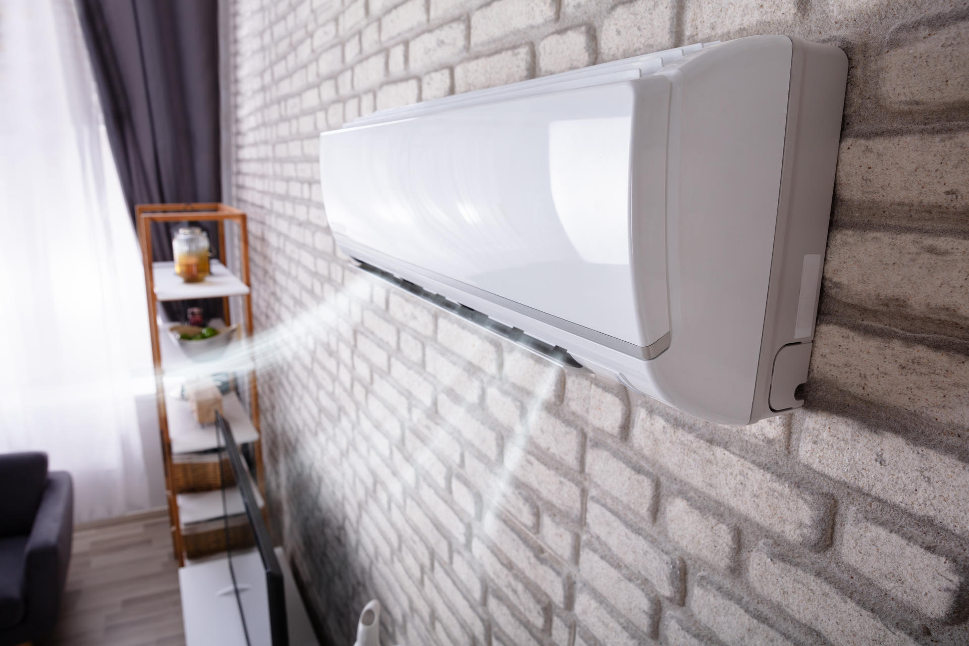 White,Air,Conditioner,Blowing,Cold,Air,On,Brick,Wall,In
